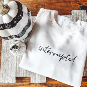 "interrupted" White Sweatshirt